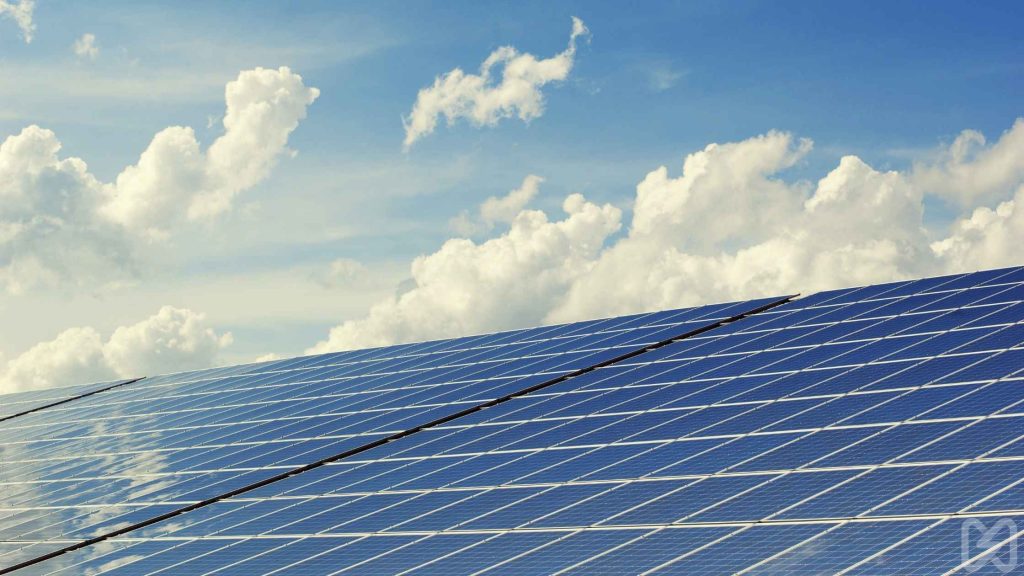 How to Finance Your Solar Solution" – Rows of solar panels under a bright sky depict solar installation as a cost-effective energy solution.